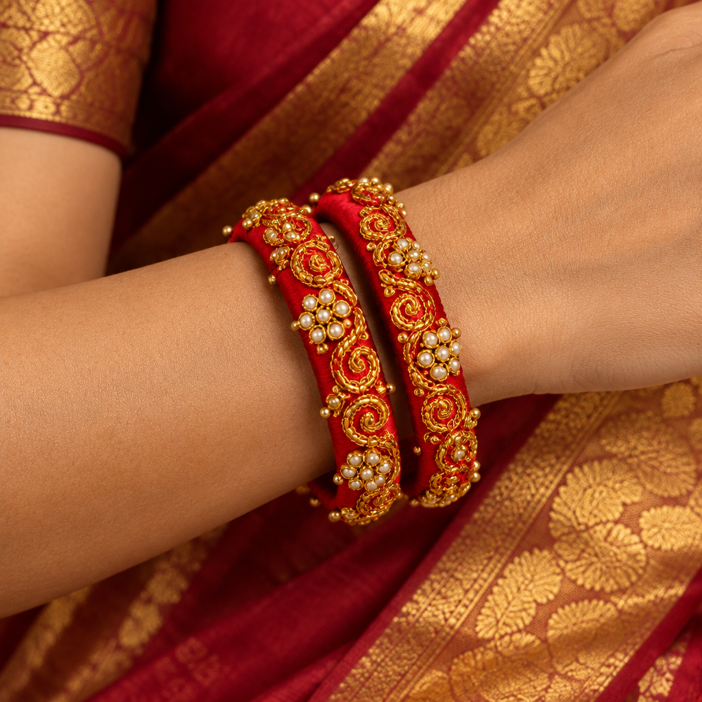 Square lifestyle image of two Red moti raw silk bangles worn on one wrist